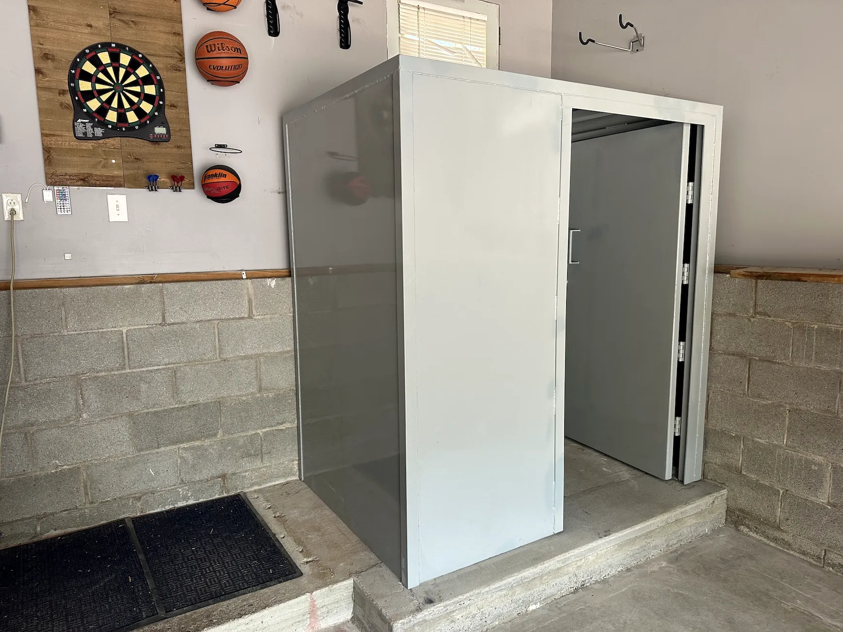 Above-ground tornado safe room installed inside a residential garage in Tennessee