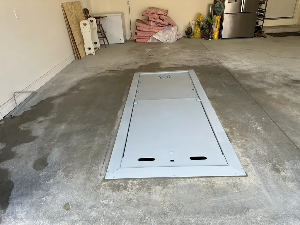 Flush-mounted garage storm shelter installed in a Tennessee residential garage